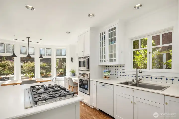 Enter a bright, airy kitchen outfitted with high-end appliances, including the allure of a built-in gas range — everything needed for a true chef’s experience.