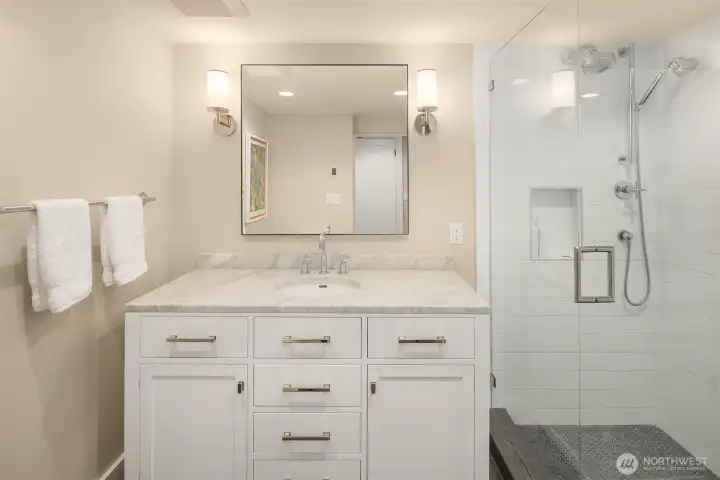 The lower-level bedroom suite includes a full bathroom, offering privacy and comfort.