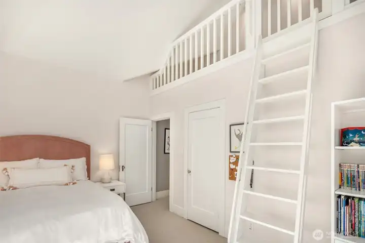Custom-built loft provides a versatile space for play, relaxation, or private retreat.