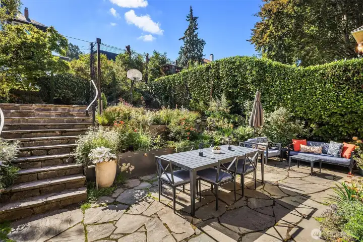 The mature garden, featured in The Seattle Times, is enhanced with irrigation and professionally curated floral arrangements.
