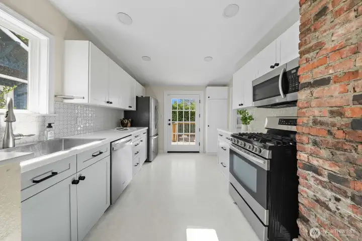Updated cabinetry, countertops, appliances, and large kitchen sink.