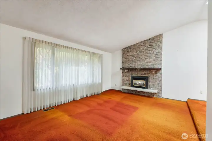 Unstaged living room with natural gas fireplace