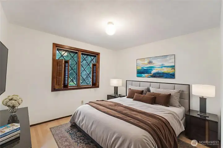 Virtually staged 2nd bedroom. Folding wood shutters are real.