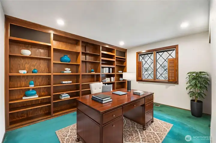 Bed number 3 with built in bookcases. Desk, rug, shelf items and floor plant are virtually staged