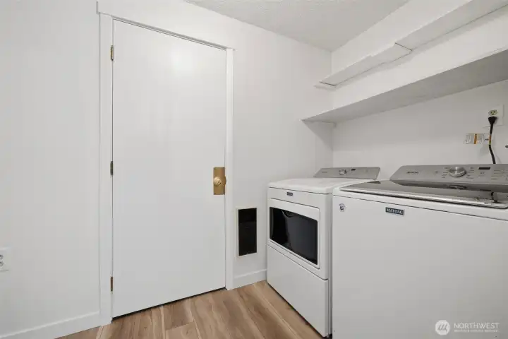 Utility room with door to attached garage.