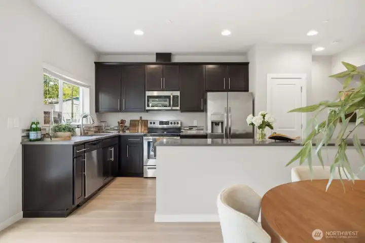 Kitchen with lost of counter space and pristine Quartz countertops.