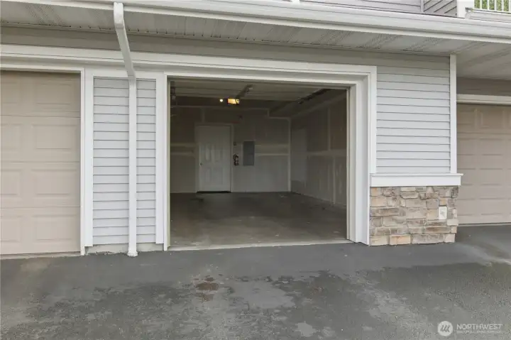 Attached single car garage with additional stoarge.