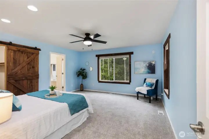 Primary bedroom with new carpet, walk in closet and 5pc bathroom