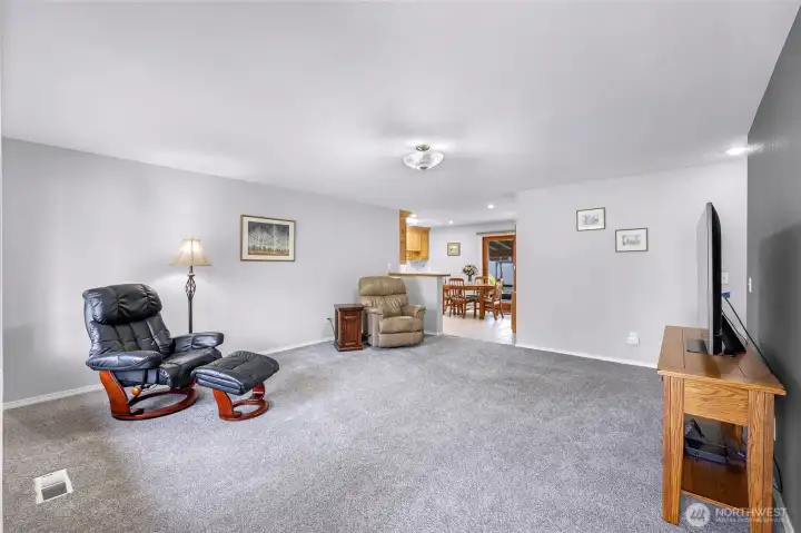 Enter the home into the large main living space, filled with bright natural light.