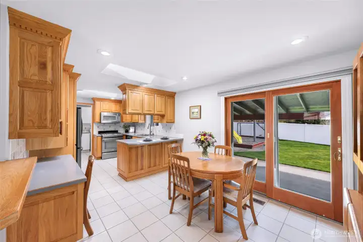 Enter the kitchen you have clean crisp finishes, plenty of room for dining with additional eating space and direct access to your incredible out door patio and backyard through your custom Anderson slider