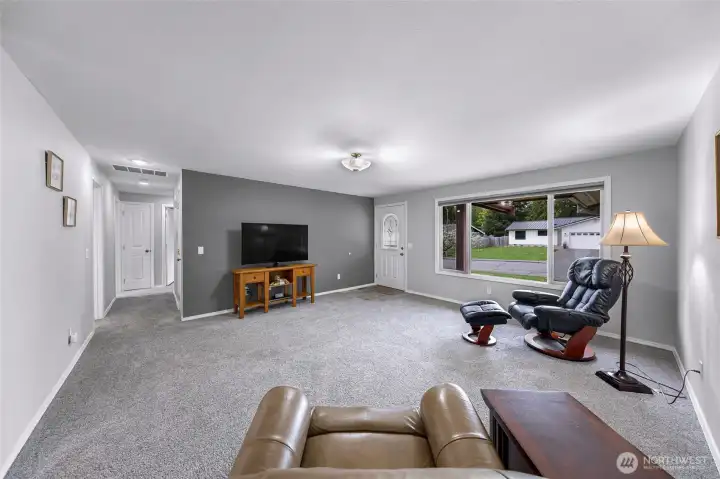 Looking from the living area down the hallway to baths and bedrooms