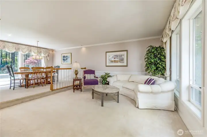 Seamlessly connected formal living and dining rooms. Large windows flood the home with light and offer picturesque views of both the front and back yards.