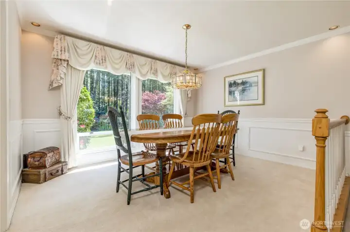 Spacious formal dining room with garden views and elegant architectural details.