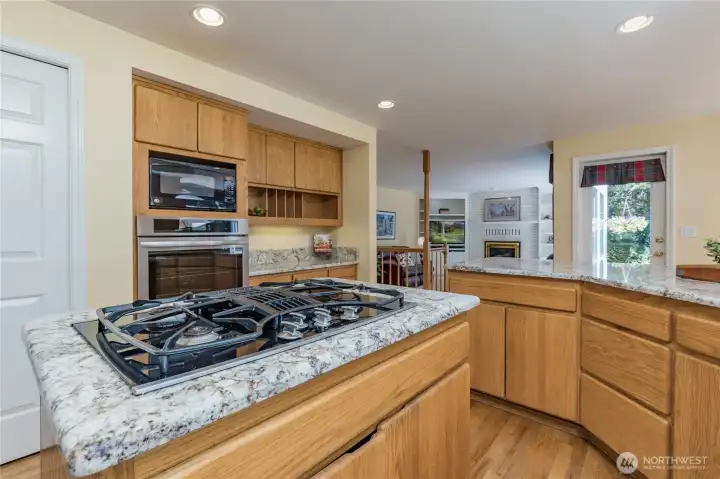 Gourmet kitchen design with a functional center island, gas cooktop, and expansive granite counters.