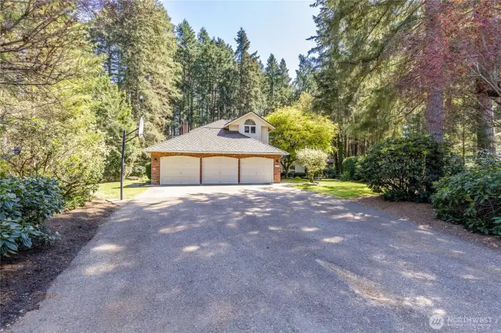 Ultimate privacy at the end of a secluded cul-de-sac. Features a spacious 3-car garage and a GenTran backup power system, perfectly blending modern convenience with a peaceful forest setting.