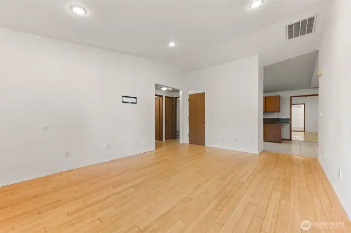 Living room, facing kitchen and hallway with bedrooms