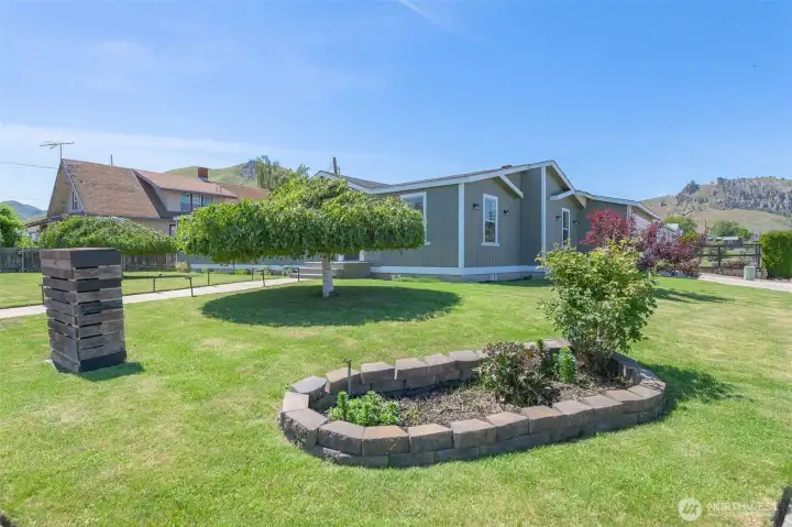 Appealing landscaping even includes a barnwood screen to disguise the PUD box!