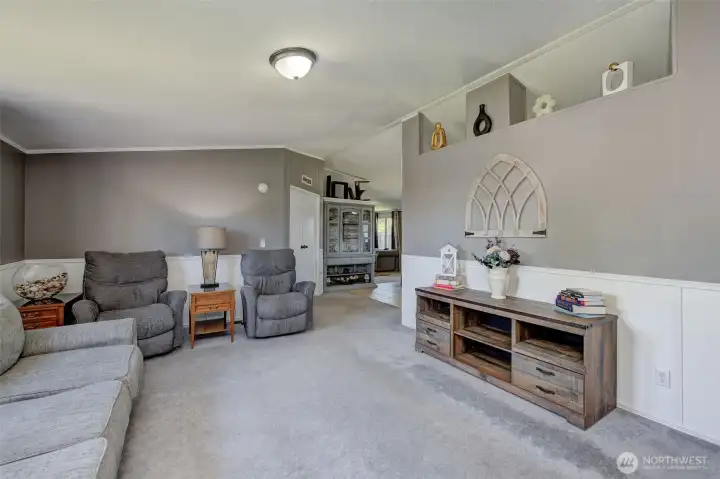 Step into this warm, inviting Living Room with vaulted ceiling, and decorated with nice wainscot trim.