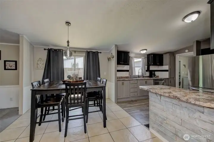 Notice the warm colors, wainscot, and contemporary lighting continues throughout Dining Area and into the Family Room..