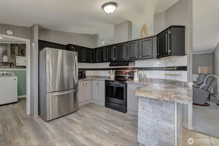 This Kitchen really has a custom feel with choice of barnwood, tile, colors and fixtures...and plenty of space to get creative with cooking!