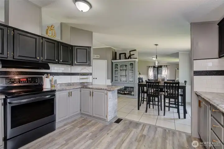From the Kitchen looking into the Dining Area and Family Room beyond...