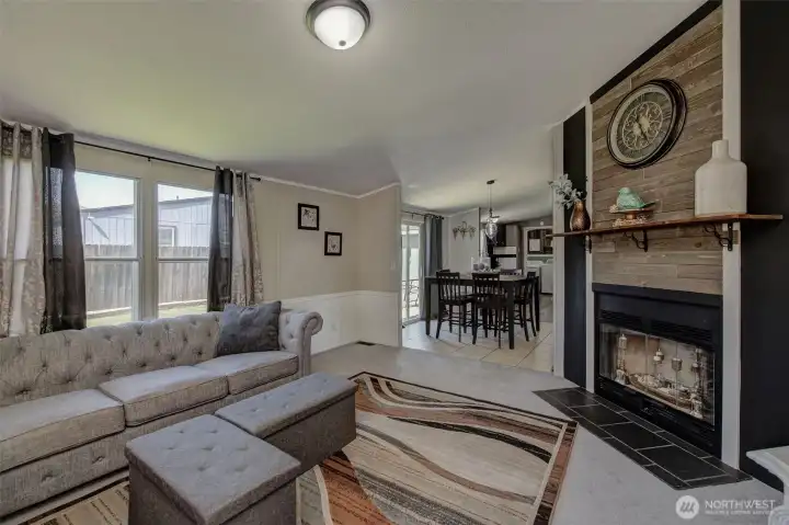 Family Room offers a cozy wood fireplace, warm colors, pretty wainscot and plenty of space for gatherings!