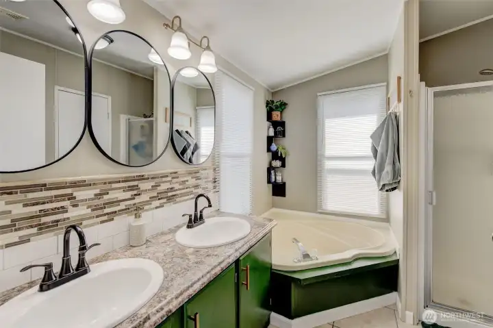 Primary Bath remodeled with custom colors, upscale fixtures, and features a dual vanity, garden tub and separate shower