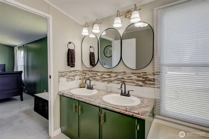 Primary Bath remodeled with custom colors, upscale fixtures, and features a dual vanity, garden tub and separate shower