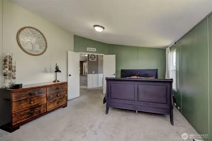 Primary Bedroom feels airy with 2 sets of windows and a vaulted ceiling. Freshly painted!