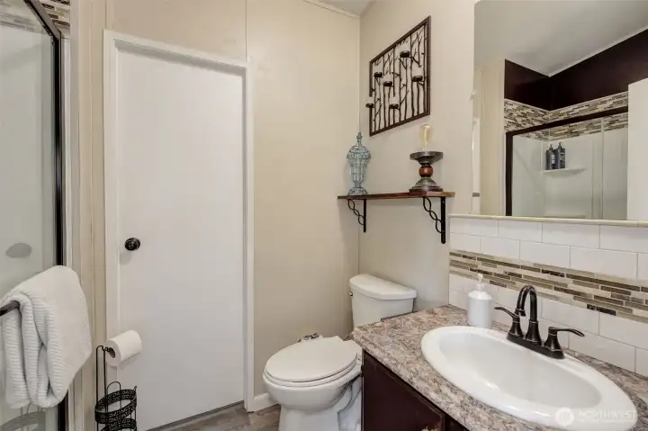 Full-sized Main Bathroom has been remodeled with pleasing colors, classy fixtures, and an oversized walk-in shower.