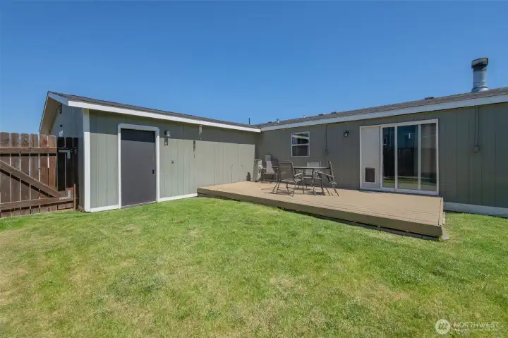 Back yard is irrigated and fully fenced, with a view from the Kitchen! The door at left goes into the Garage... The panel in the sliding door can easily be removed.