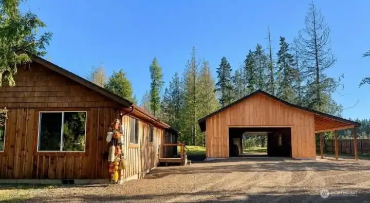 View of both garage doors open, showcasing convenient drive-through access, excellent functionality, and versatile space for vehicles, equipment, storage, or workshop use. View of both garage doors open, showcasing convenient drive-through access, excellent functionality, and versatile space for vehicles, equipment, storage, or workshop use.