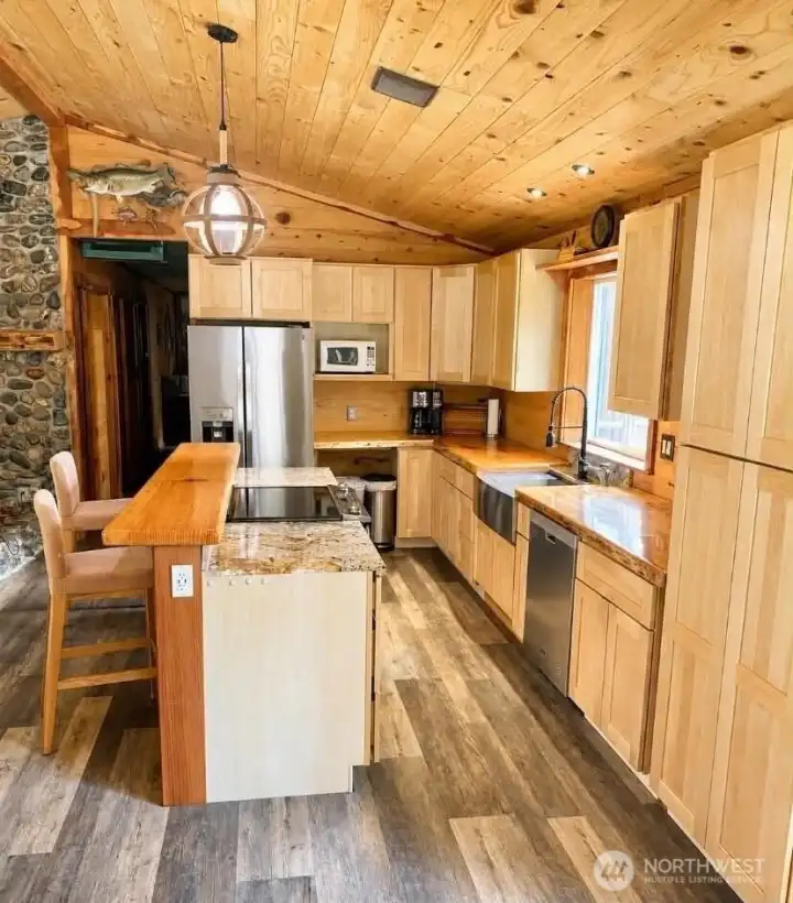 Warm and inviting kitchen with stainless steel appliances, farmhouse sink, natural wood cabinetry, and finishing hardware to be installed. Warm and inviting kitchen with stainless steel appliances, farmhouse sink, natural wood cabinetry, and finishing hardware to be installed.