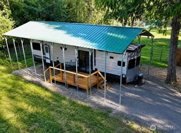 A separate RV carport provides flexible space with plenty of room for future possibilities. Previously utilized as a successful Airbnb/VRBO rental area, this versatile space offers potential for guest accommodations, hobby use, storage, or other creative opportunities. A separate RV carport provides flexible space with plenty of room for future possibilities. Previously utilized as a successful Airbnb/VRBO rental area, this versatile space offers potential for guest accommodations, hobby use, storage, or other creative opportunities.