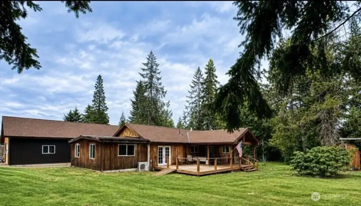 The expansive porch provides ample space for year-round grilling, gathering, dining, or simply enjoying the surroundings. The expansive porch provides ample space for year-round grilling, gathering, dining, or simply enjoying the surroundings.