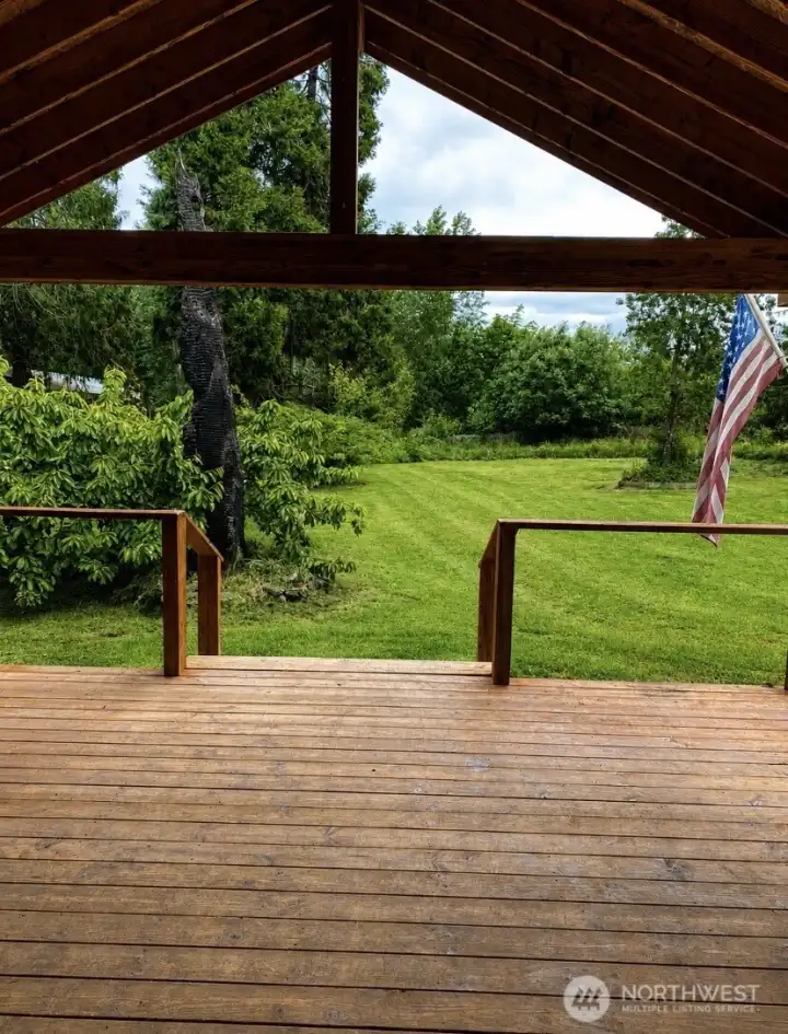 Large covered porch offers a sheltered space to relax and entertain year-round. Large covered porch offers a sheltered space to relax and entertain year-round.