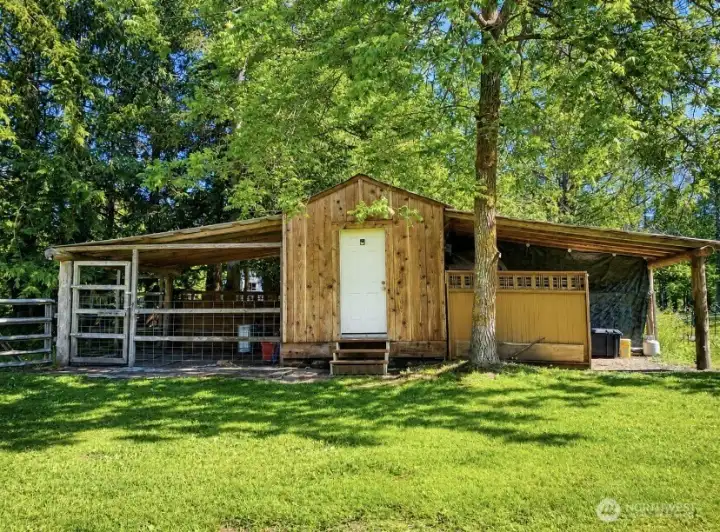 Versatile outbuilding featuring a central tack room, horse stall on one side, hay storage on the other, and an additional small stall located behind the hay storage. Versatile outbuilding featuring a central tack room, horse stall on one side, hay storage on the other, and an additional small stall located behind the hay storage.