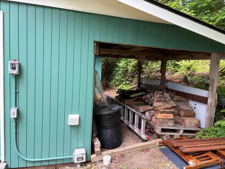 Covered wood storage space.