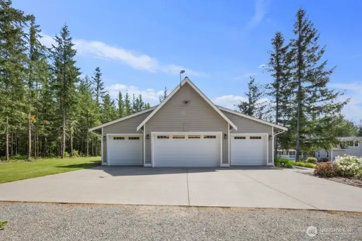 View of your 4 car heated garagspanning over 2,000 sq. ft. Wired for EV charger.