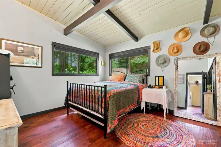 Relaxing main bedroom suite with beautiful architectural details and peaceful views of the surrounding property. Relaxing main bedroom suite with beautiful architectural details and peaceful views of the surrounding property.