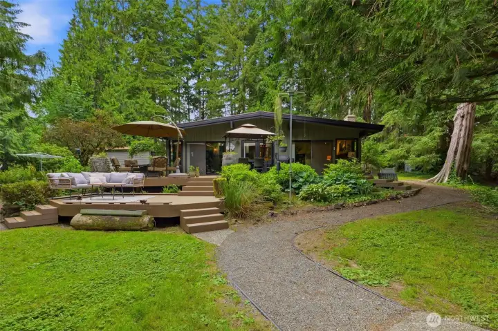 View from the backyard showcasing the newer composite deck overlooking the lawn and creek. View from the backyard showcasing the newer composite deck overlooking the lawn and creek.