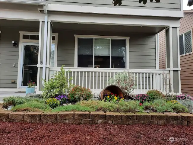 Lovely flowerbeds & covered front porch.