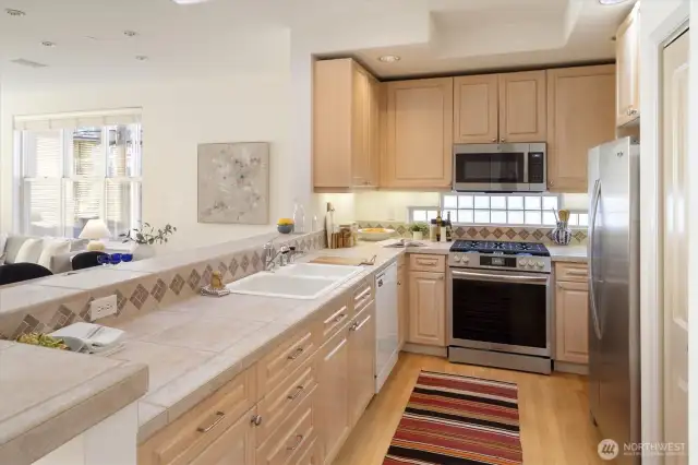 The kitchen features some newer Stainless appliances, plenty of cabinetry and space for busy cooks.