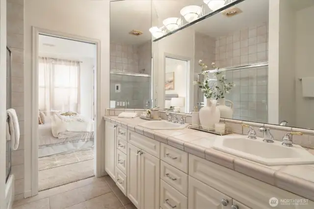 This bathroom was beautifully designed with a cabinet featuring side by side sinks and lots of cabinets.