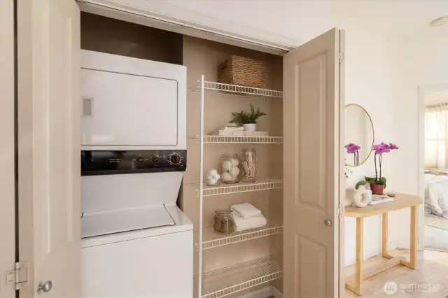 The in-unit laundry is tucked just off the kitchen and has shelving for your laundry items.