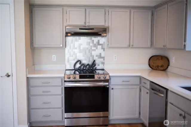 Professionally painted gray wood cabinets and a convenient pantry