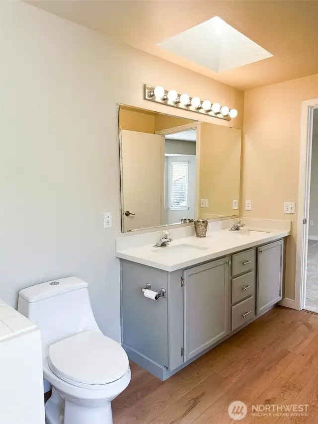 Primary Ensuite 5-piece Bathroom with skylight and double sinks & adjacent walk-in closet