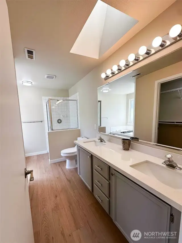 Spacious Primary Bath with LVP & New Quartz Counters and tile shower