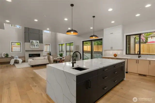 Kitchen island with waterfall countertop and prep sink with second garbage disposal