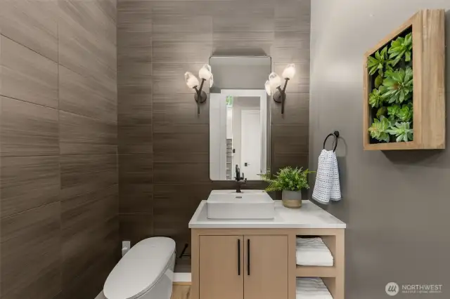 Designer powder room with smart toilet and full height tile walls